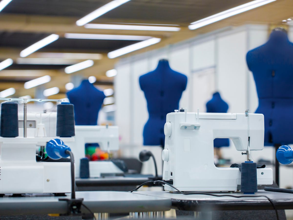 Sewing machines and dress forms in a fashion institute classroom, showcasing fashion designing courses in Mumbai.